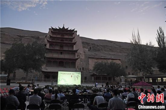 2018年8月，在敦煌莫高窟標(biāo)志性建筑“九層樓”前，《回顧平山郁夫先生的貢獻(xiàn)》座談會舉行。來自中日兩國的專家、學(xué)者共同懷念這位情系敦煌數(shù)十載的繪畫巨匠、中日友好的文化使者、世界文化遺產(chǎn)的守護(hù)者。中新社記者 楊艷敏 攝